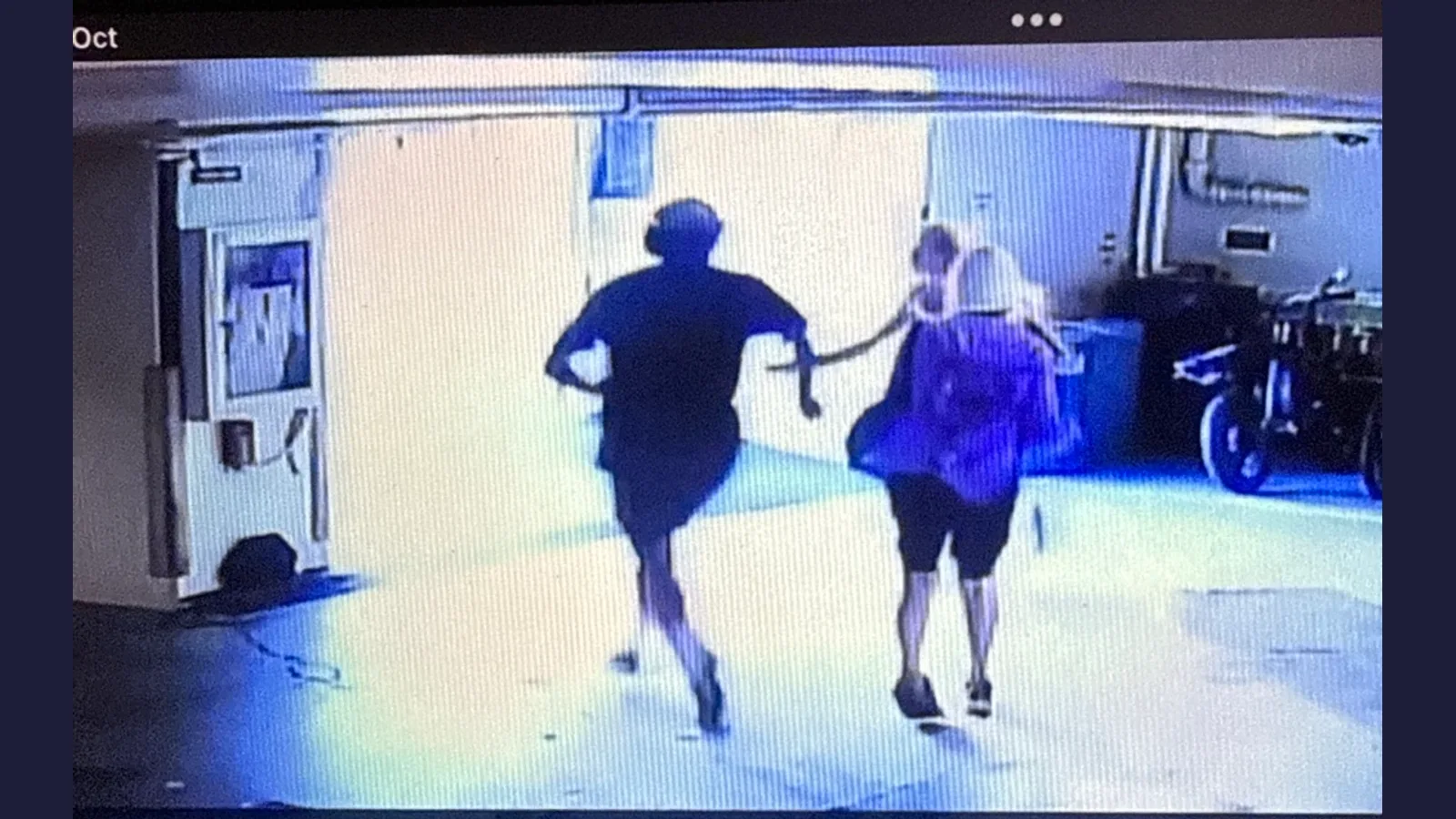 Surveillance still shown by NBC News: two people running in a Honolulu parking garage during a reported kidnapping attempt